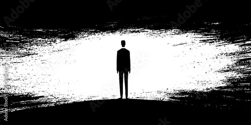 Silhouette of solitary figure against abstract black and white background