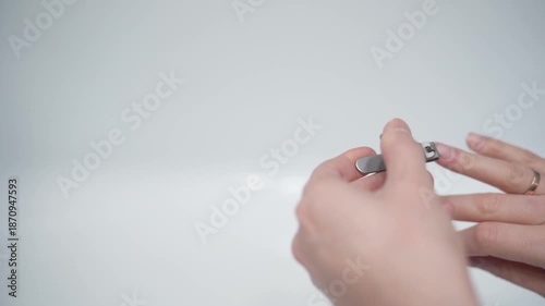 Cutting nails on a man's hand with nail tongs on a white background. Care for hands.