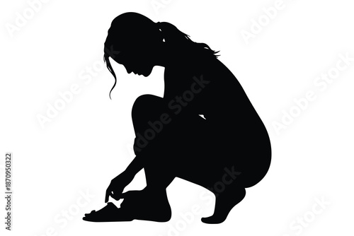Black silhouette of a person tying shoelaces