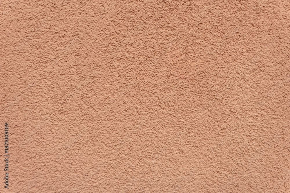 Fototapeta premium Pink stucco wall with rough texture. Plastered surface background.