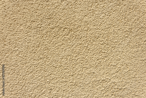 Beige stucco wall with rough texture. Plastered surface background.