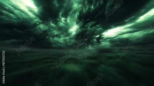 Dramatic storm clouds rolling across a dark green horizon