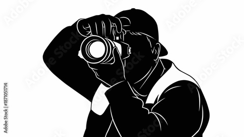 Silhouette of a photographer holding a camera and taking a picture.