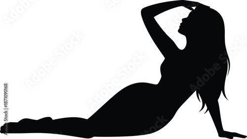 Silhouette of a woman with long hair stretching her arms upwards in a yoga pose on the ground