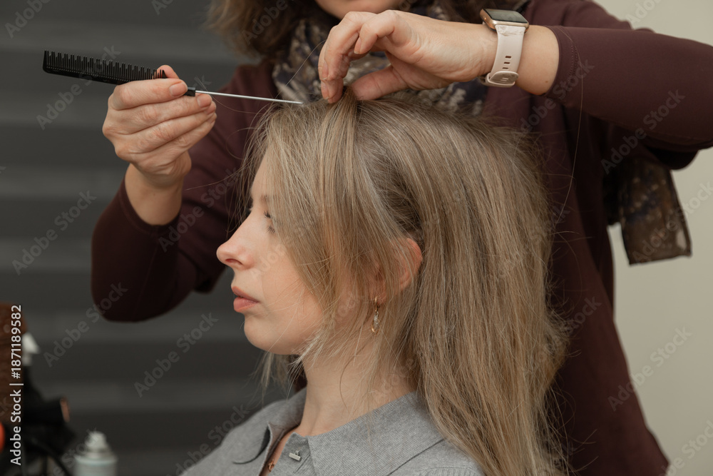 Fototapeta premium Hairstylist Adjusting Hairline of Adult Woman During Styling