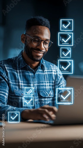 Young man interacts with glowing digital checklist symbols while working on a computer device