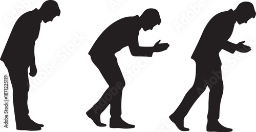 Silhouettes of a man looking at his phone downward