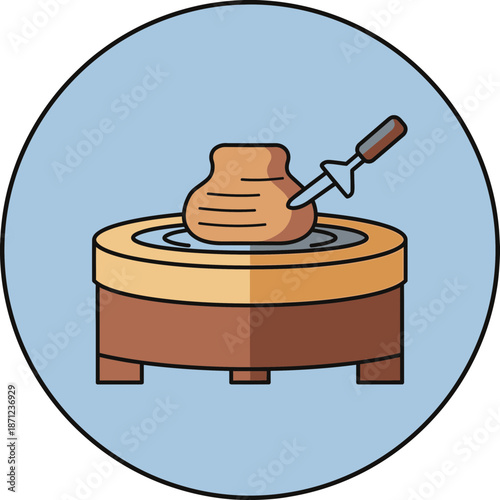 Pottery wheel shaping clay with a tool.