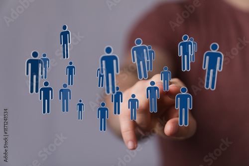 Hand pointing at human figu...