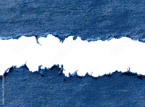 Ripped denim fabric with a black hole