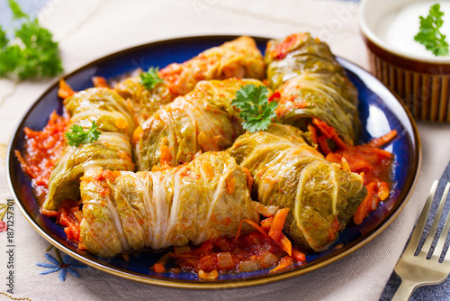 Cabbage rolls on blue plate. Chou farci, dolma, sarma, golubtsy or golabki