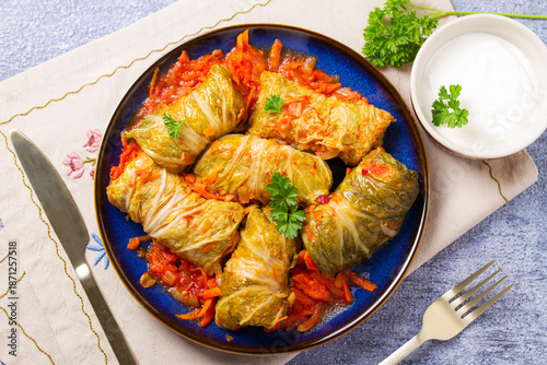 Cabbage rolls on blue plate. Chou farci, dolma, sarma, golubtsy or golabki. Flat lay, high angle view