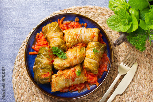 Cabbage rolls on blue plate. Chou farci, dolma, sarma, golubtsy or golabki. Flat lay, high angle view