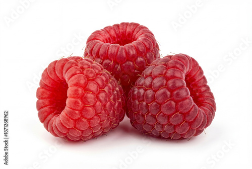 Three fresh ripe red raspberry fruits isolated on white background macro closeup