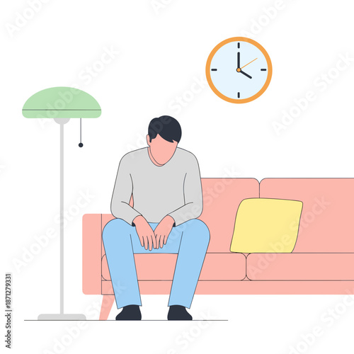 Young man sitting alone on couch looking pensive in modern interior  