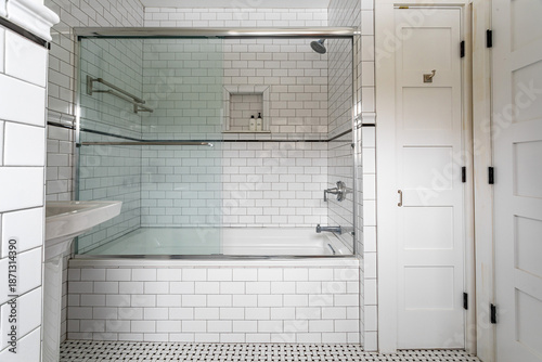 Quadro su tela Classic white bathroom with subway tile and glass shower tub combination, bright