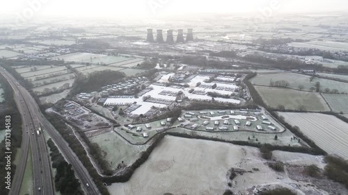 Aerial drone footage pushing forward over Mercia Marina in Derbyshire, England, showing canal boats, lodges and surrounding infrastructure, suitable for travel, tourism and establishing shot use.