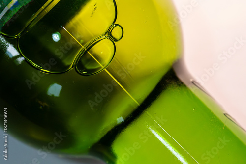 abstract macro shot of air bubbles in a green glass bottle with liquid