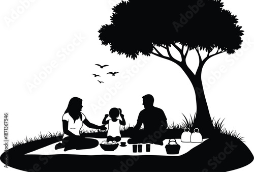 Silhouette illustration depicts a happy family enjoying a peaceful outdoor picnic together under the shade of a large leafy tree with birds flying above them