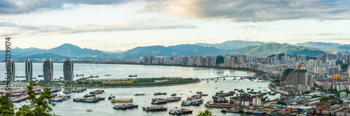 Bird eye panorama of the Sanya city bay with green mountains in the horizon. View from Luhuitou Park on Hainan Island of China.