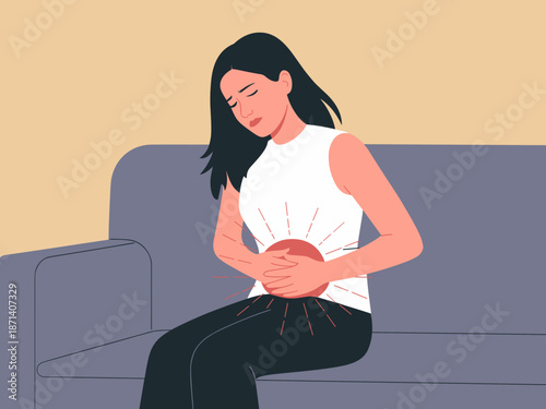 Young woman experiencing abdominal pain stomach ache cramps sitting on sofa at home upset girl suffering from period pain menstrual cycle endometriosis health problem illness medical condition healthc