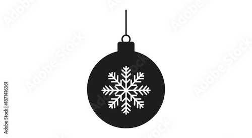 A simple black christmas ornament with a snowflake design hangs suspended isolated on white