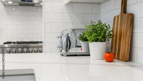 Modern Kitchen Counter with Toaster, Herbs, and Tomato on White Surface with Wooden Cutting Board