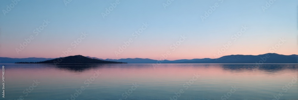 Obraz premium Serene lake at sunrise with calm waters and mountain silhouette