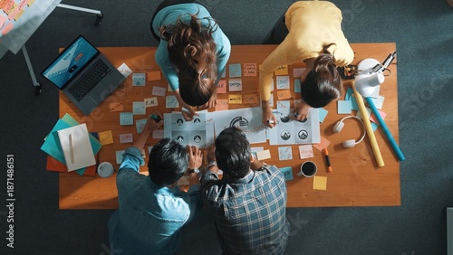 Foto Top view of business team write graphic logo on meeting table with colorful sticky notes and design while explain idea