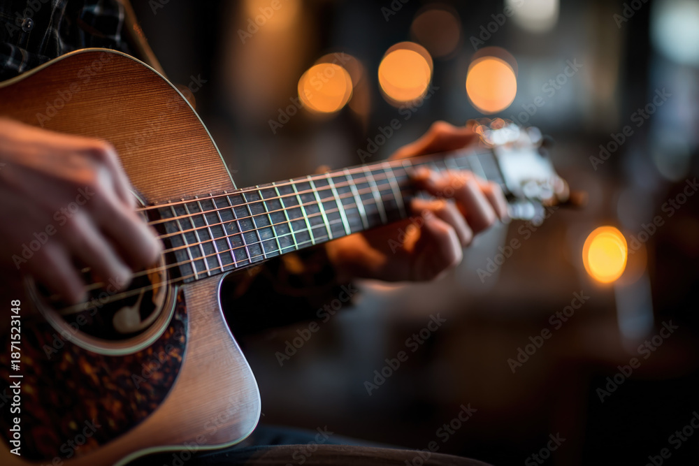 Obraz premium Cozy Live Music Vibes: Close-Up of Hands Strumming Guitar Strings with Soft Lighting and Bokeh Background