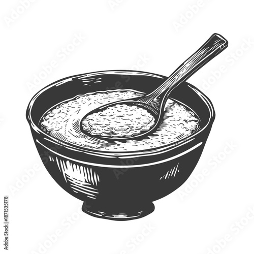 A bowl of porridge with a wooden spoon
