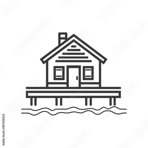 A lakeside house sits on stilts above the water