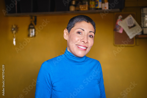 Canvas Print confident Non-binary hispanic adult with short hair smiling at camera