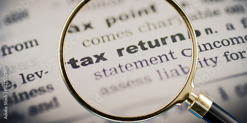 Canvas-taulu magnifying glass hovering over text saying tax return, paying taxes