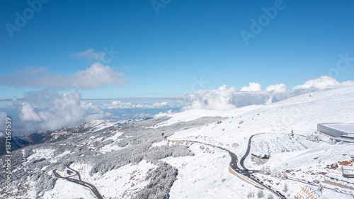 Aerial photo from dronet to Sierra Nevada ski resort on a sunny winter day in the mountains, Spain. Sierra Nevada is the largest mountain range near the city of Granada in Spain with snow. Sierra Neva