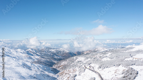 Aerial photo from dronet to Sierra Nevada ski resort on a sunny winter day in the mountains, Spain. Sierra Nevada is the largest mountain range near the city of Granada in Spain with snow. Sierra Neva