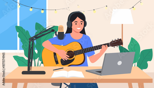 Woman playing guitar and recording music on laptop at home.