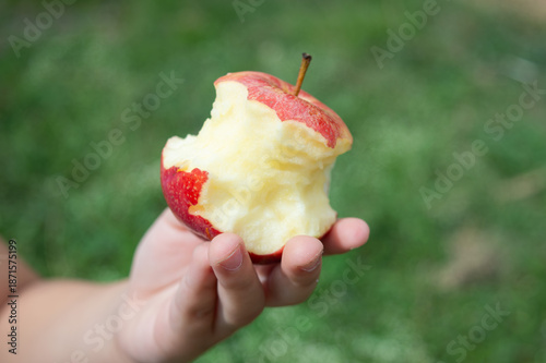 фотографія girl holding a bitten apple,
