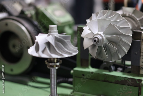Canvastavla Turbocharger turbine shaft and compressor wheel assembly on a professional balancing machine, precision mechanical engineering components for automotive engine repair and maintenance