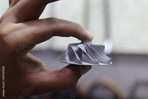 Bild auf Leinwand A person holding a high-performance silver aluminum turbocharger compressor wheel, precision turbine impeller part for automotive engine induction and mechanical boost systems