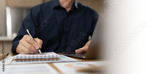 Business professional reviewing and signing financial documents with pen on desk. Corporate paperwork, audit process, accounting review, compliance, administration, and professional business workflow 