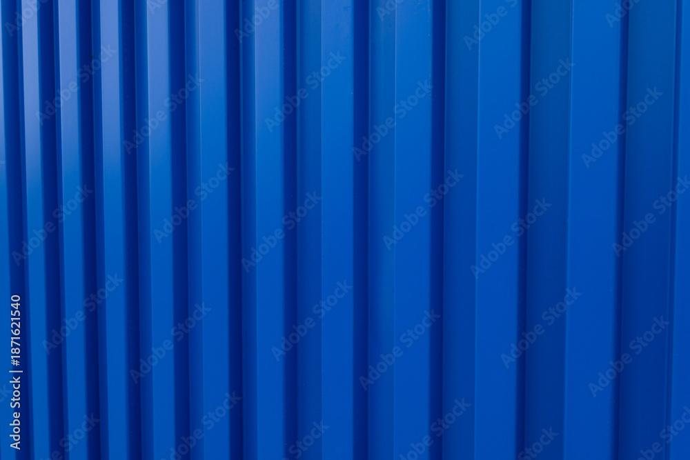 Obraz premium Blue Corrugated Metal Sheet Texture Background,High angle view of blue corrugated metal wall or roofing sheet with diagonal lines. Abstract geometric background of industrial material with repeating 