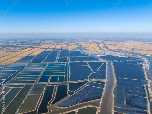 Fotografie Village, fishpond, solar photovoltaic panels and paddy fields