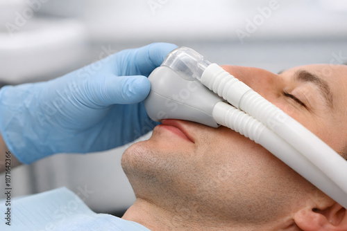 Dental Professional Holding Sedation Mask