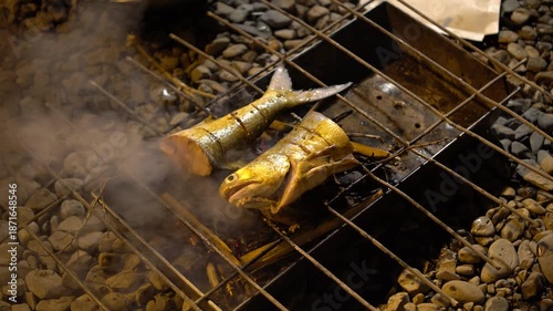 The traditional process of grilling fish at night.