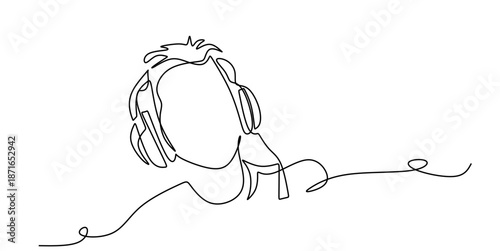 Woman sitting and listening to music on headphones in a relaxed pose