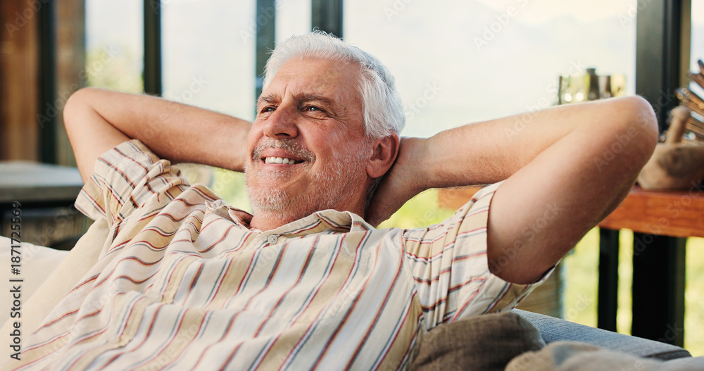 Obraz premium Thinking, senior man and relax at house with smile, peace and calm morning on couch. Confident, elderly person and comfortable on sofa, weekend break and vision with happiness in lounge on retirement