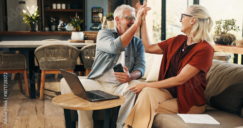House, high five and old couple with smartphone, laptop and savings with pension fund. Annuity growth, retirement and man on couch, woman and pc with gesture, investment and excited with celebration