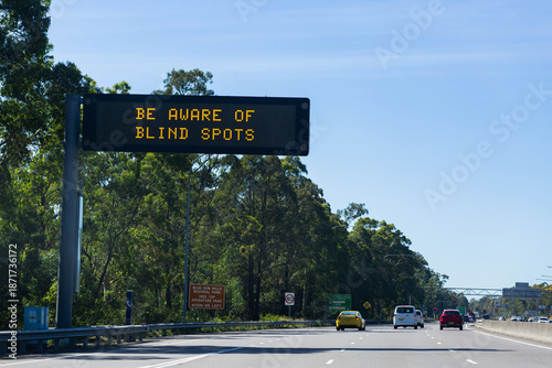 be aware of blind spots warning on digital signage above highway road