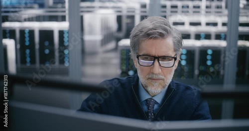 Close Up of Focused, Male Manager Carefully Monitoring Data Systems. Controlling Critical Cloud Infrastructure. Concept Critical Decision Making and High Professional Responsibility. Portrait.